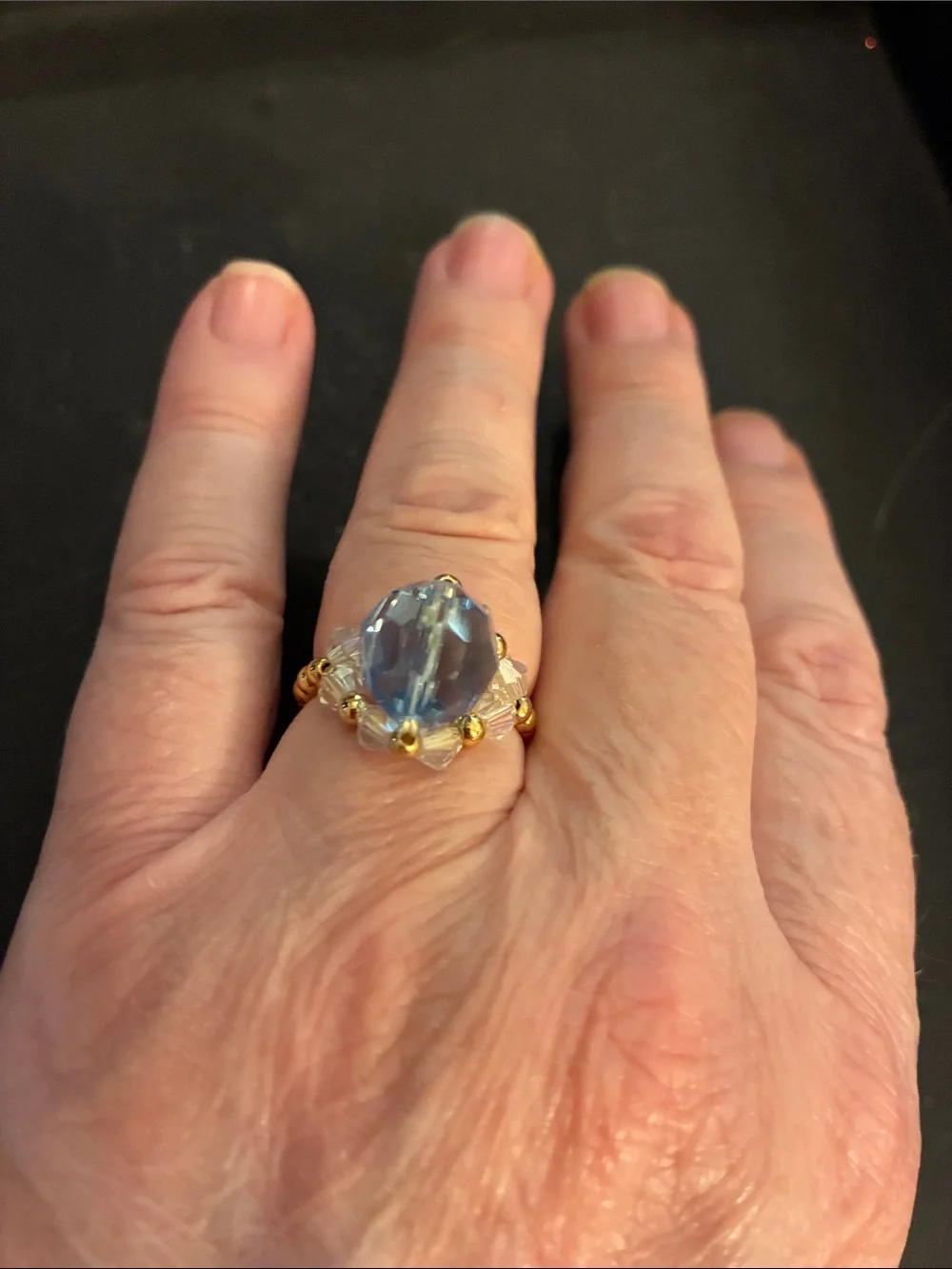 Gold-Tone Stretch Beads.Ring with Light Blue Faceted Stone and Crystal Accents.